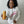 Load image into Gallery viewer, Faith reaching out a can of our lemon spritzer and smiling in a cozy white Sarilla sweatshirt, styled for a relaxed fit. The image captures the soft texture and versatile design, perfect for everyday comfort
