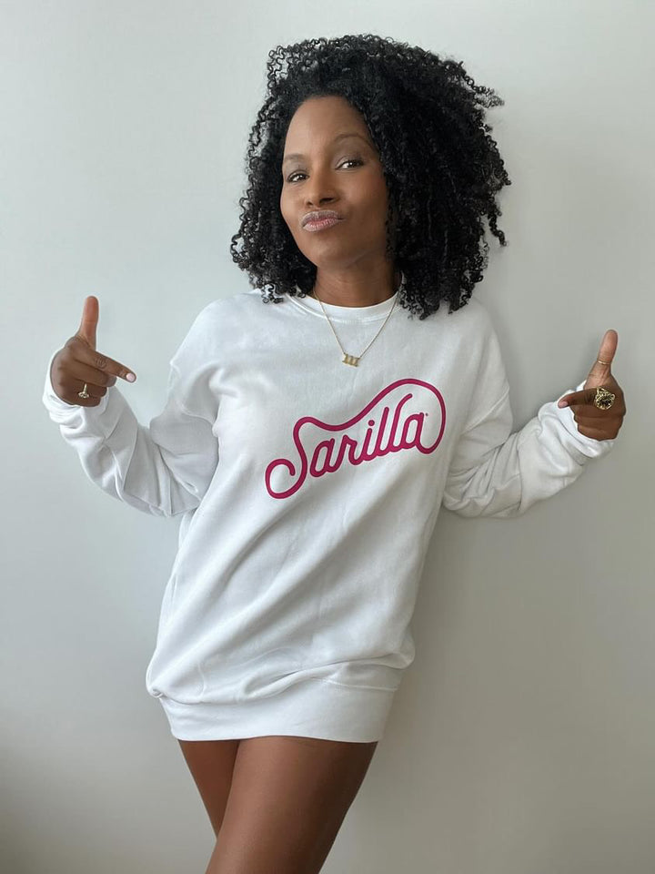Faith smiling in a cozy white Sarilla sweatshirt, styled for a relaxed fit. The image captures the soft texture and versatile design, perfect for everyday comfort
